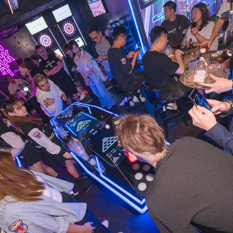 People enjoying the PongLive digital beerpong table in a social setting